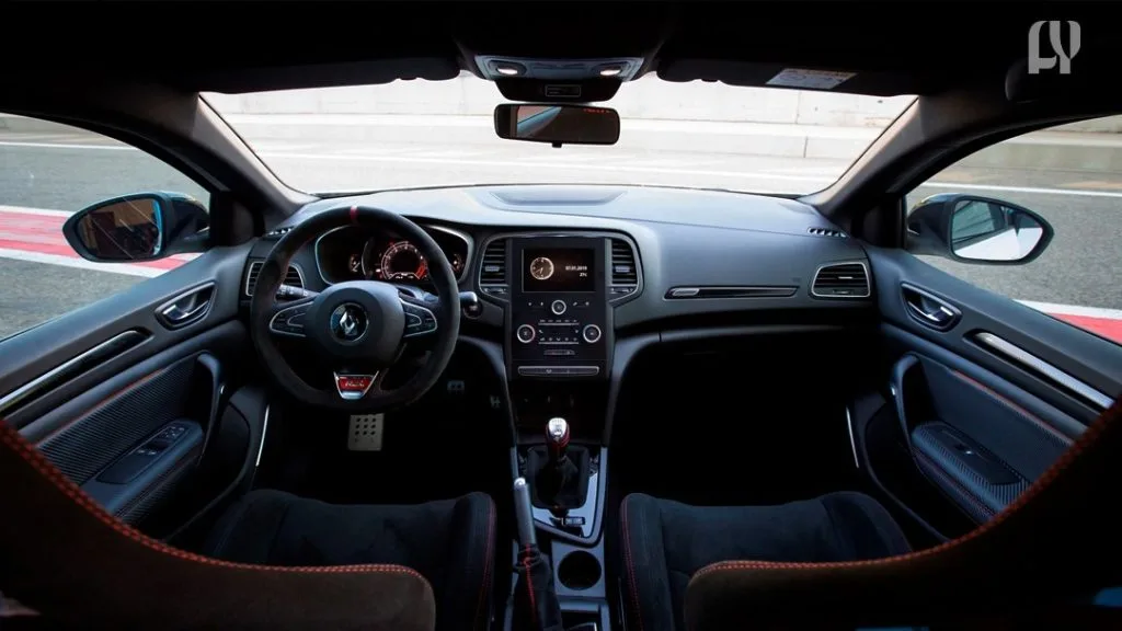 Renault Megane RS 300 Trophy speeding on a racetrack.
